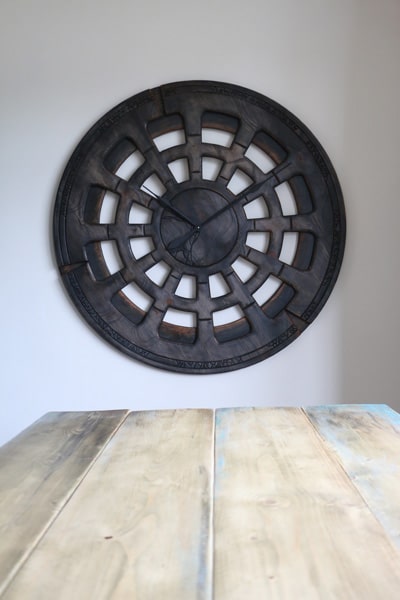 extra large clock above the wooden table